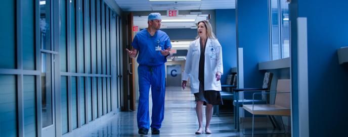 Mark Karcutskie MD and Alison Brodginaski DO walking in Hallway 

Division Chief