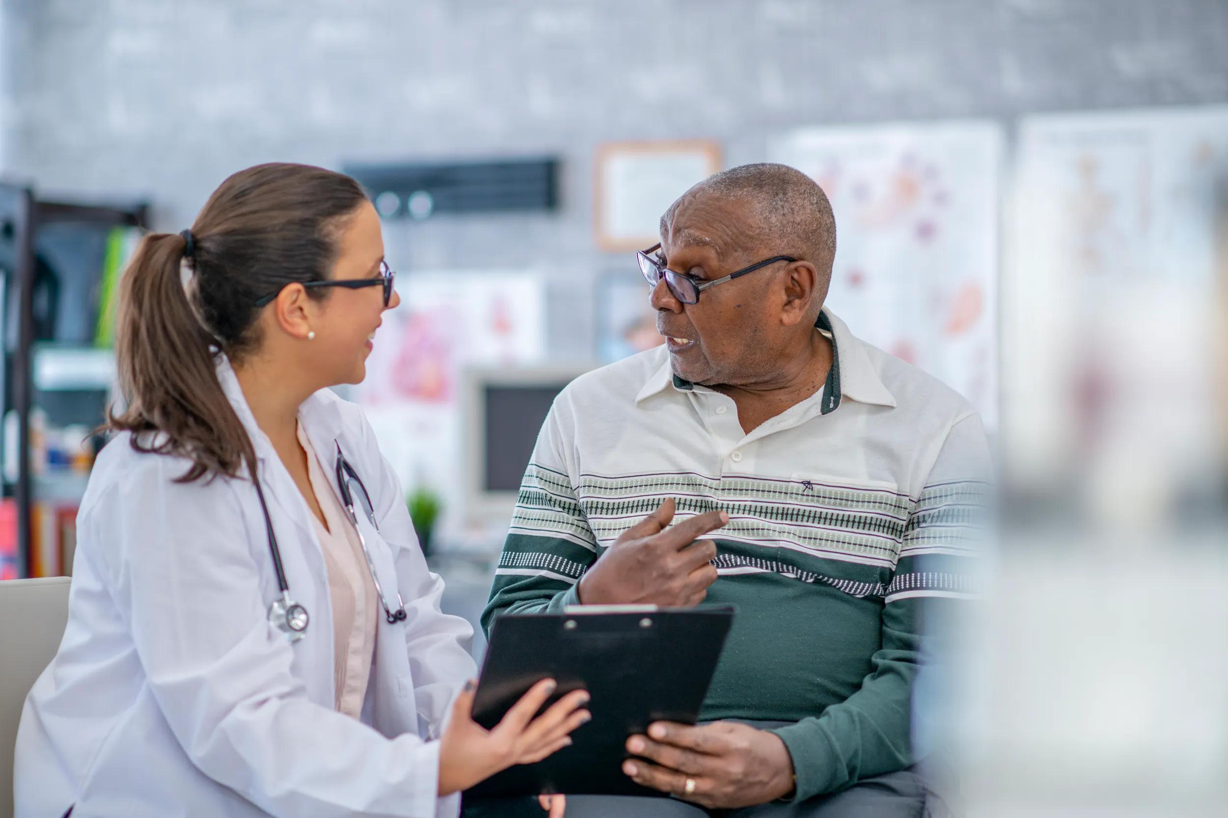 Man taking medical advice from a female doctor