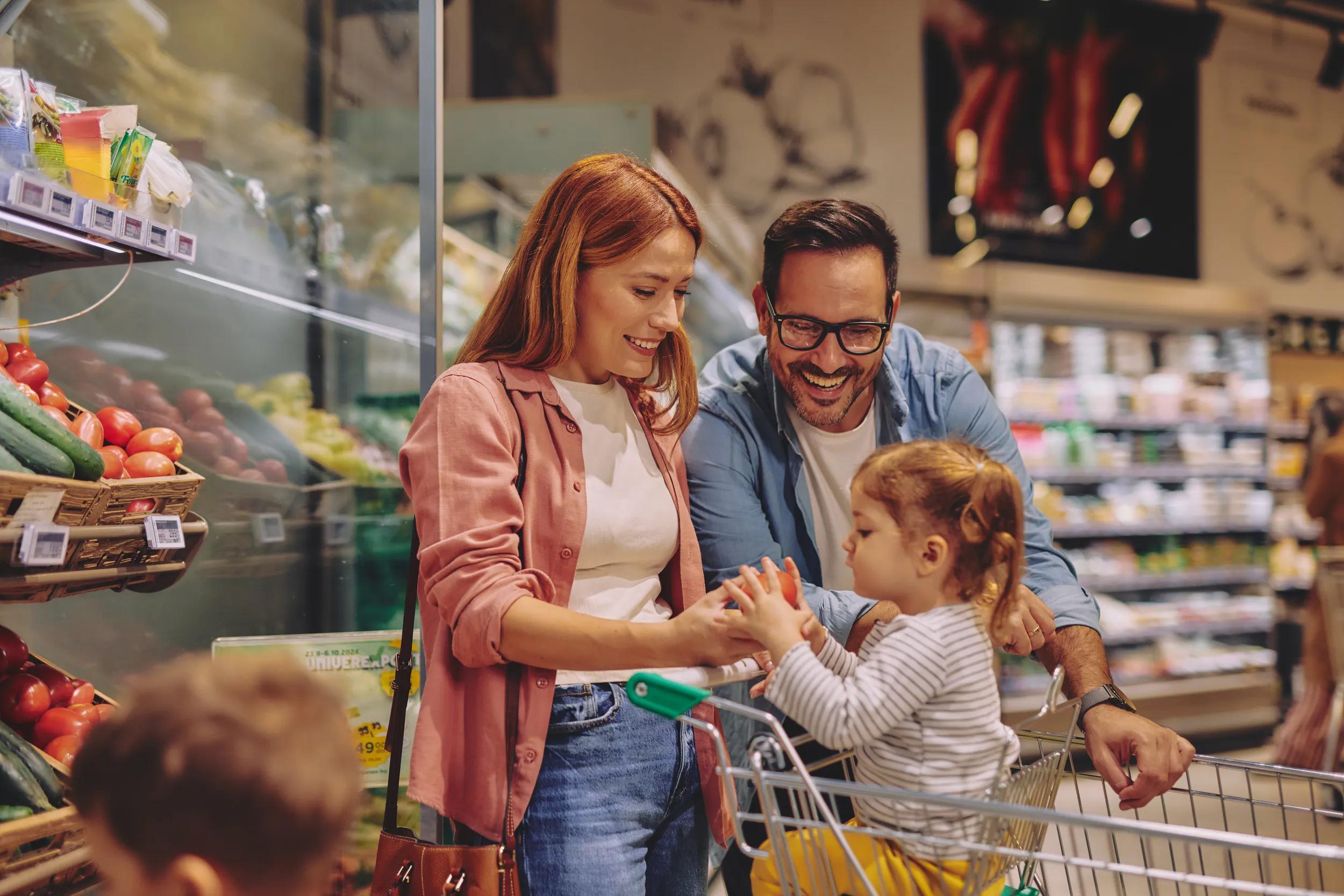 Happy Family Shopping Together in a Supermarket Aisle