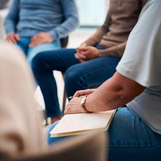 Diverse Group of People Attending a Support Group Meeting Indoors in Casual Attire