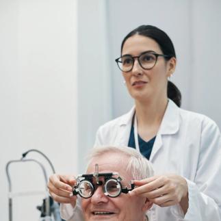 Senior Man Undergoing Eye Exam with Female Optometrist Assisting
