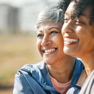 Senior women, hug and smile closeup with fitness and exercise outdoor for health. Elderly people, sport training and happy friends with excited bonding and embrace after running of a mature athlete