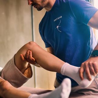 Physiotherapist performing knee examination on patient. Close-up shot in rehabilitation clinic. Healthcare and physical therapy concept.