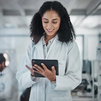 Science, research and black woman with tablet, smile and internet in laboratory with medical data. Healthcare, pharmaceutical innovation and scientist, technology and reading email, website or result