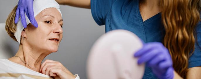 Young female doctor talks about beauty treatments during a consultation with a mature woman patient