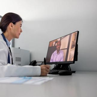 Doctor in her office talking to a patient on a video call