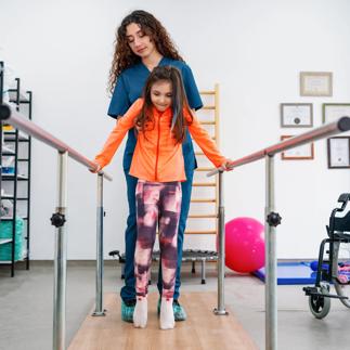 Young patient doing physiotherapy at a clinic with help of a therapist