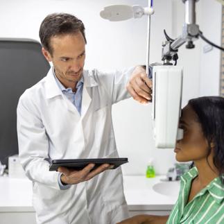 Doctor performing an eye exam on a patient