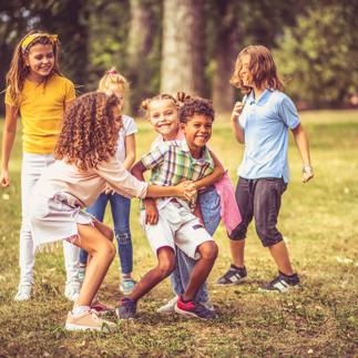 Large group of school kids having fun in nature.