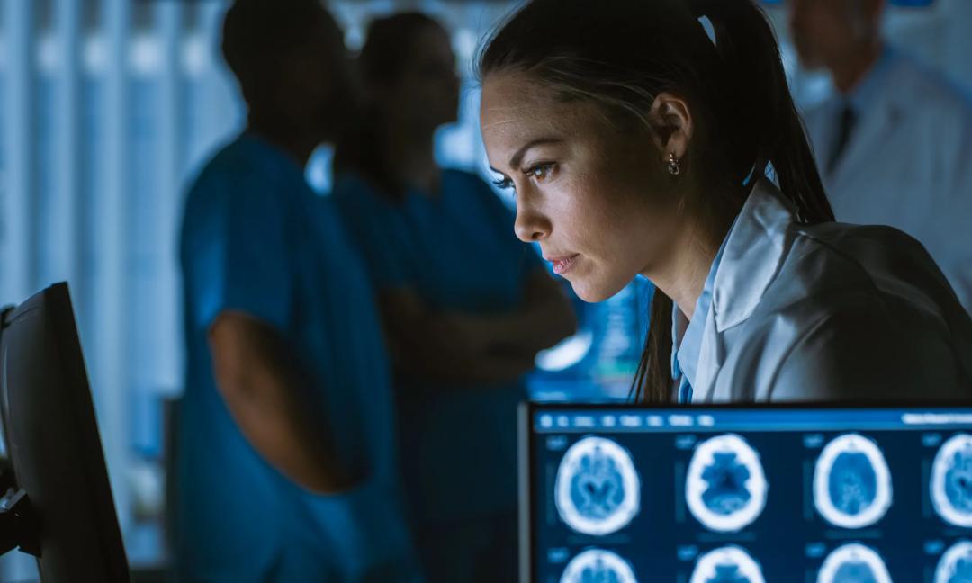 Female Medical Research Scientist / Neurologist Working on a Personal Computer in Modern Laboratory. Making New Discoveries in the fields of Neurophysiology, Science, Neuropharmacology. Understanding Human Brain.