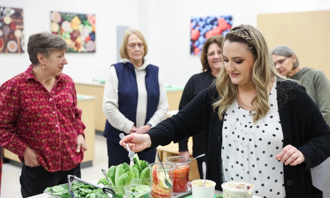 Action shots of people cooking in a Culinary Medicine Class