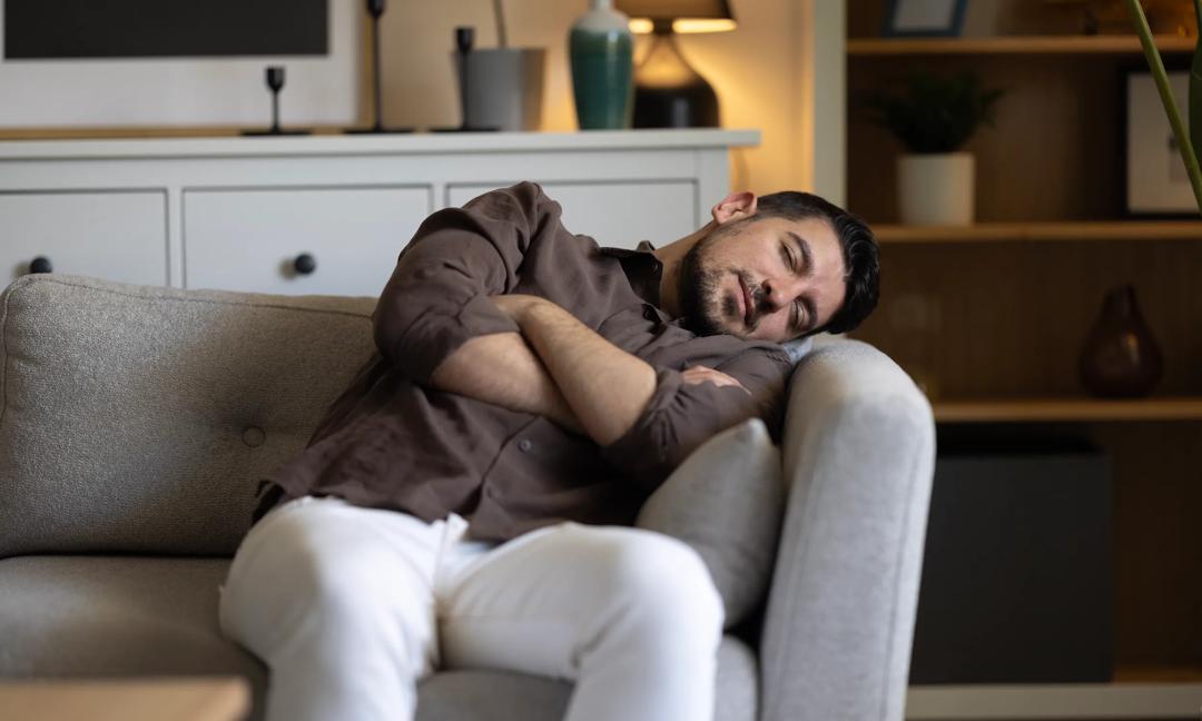 Man With Lethargy And Fatigue On Couch