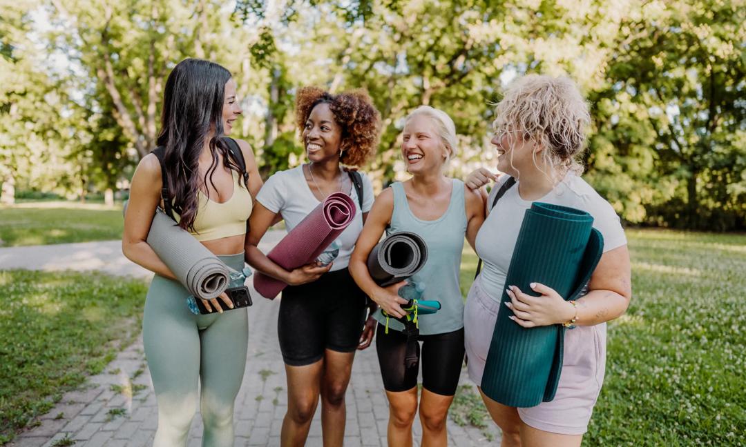 Group of women practicing yoga in the park