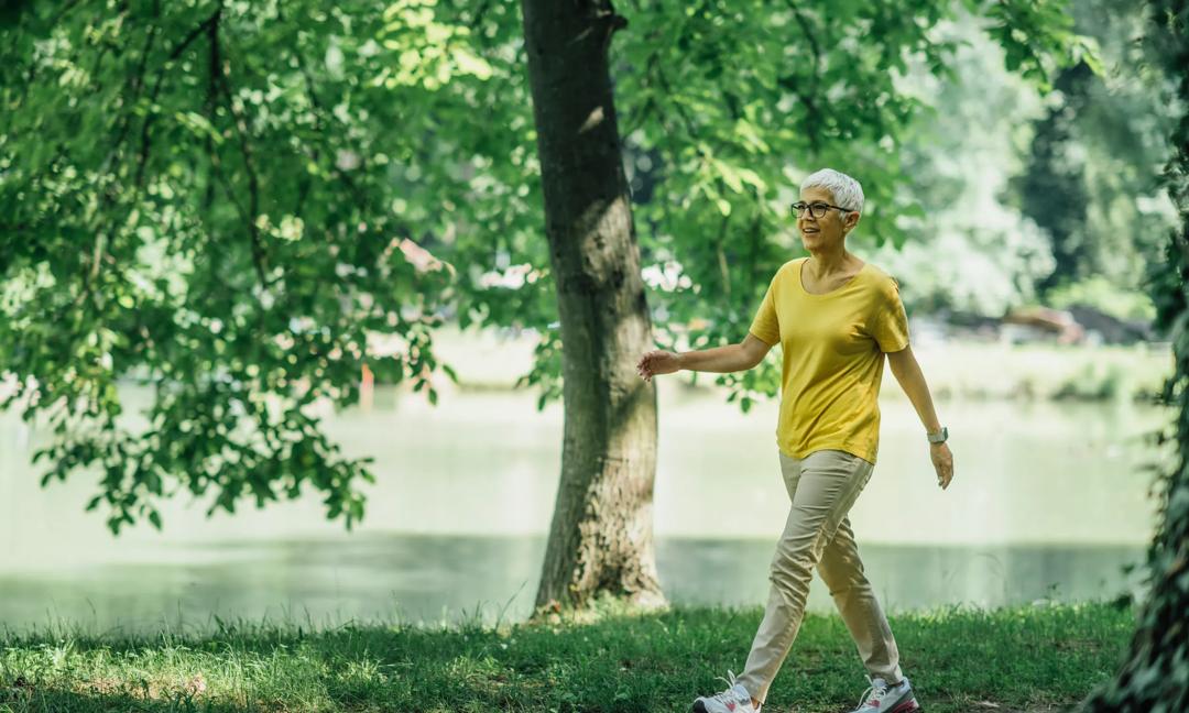 Mature Woman Enjoying Walking Exercise by the Lake
