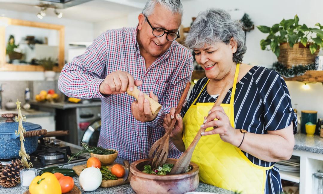 senior couple cooking dinner at home in  Latin America