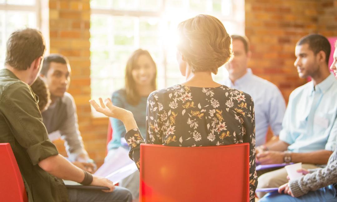Woman speaking in group therapy session