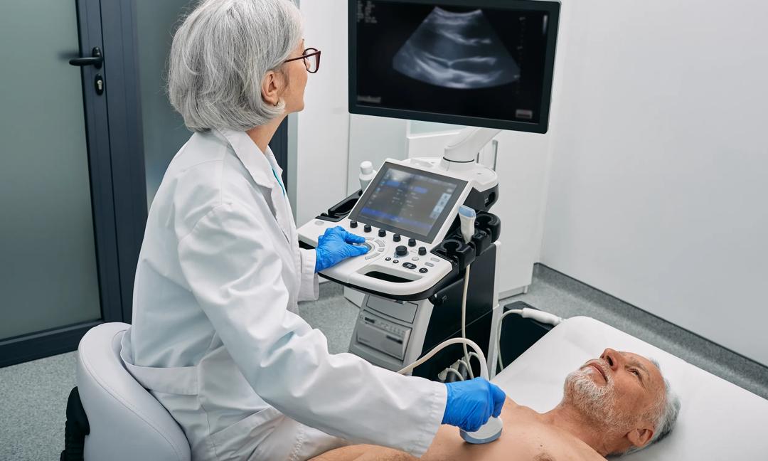 Heart ultrasound exam for senior man with ultrasound specialist while medical exam at hospital