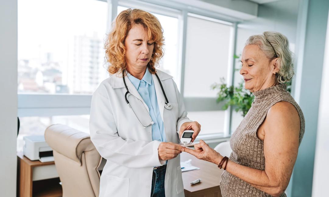 Doctor measuring senior patient's diabetes