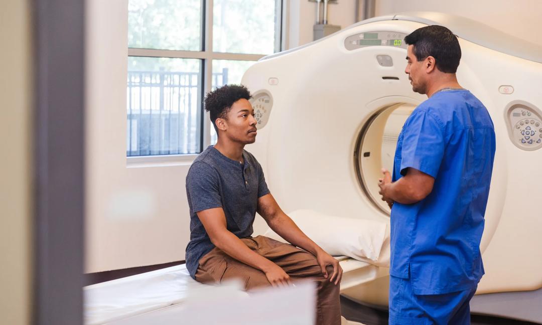 Young Man in Discussion with Healthcare Professional