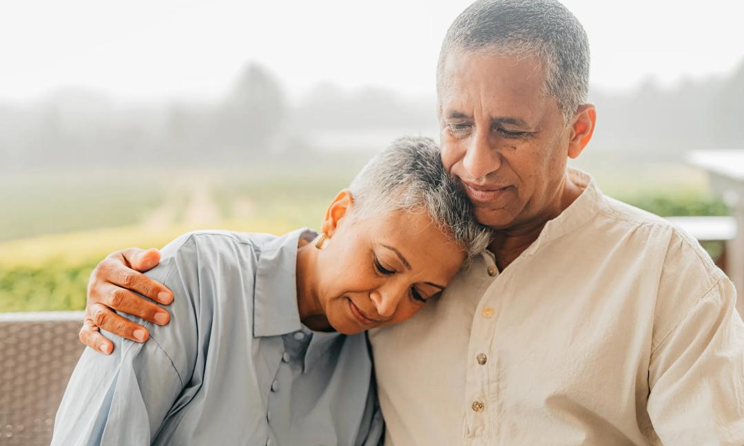 Depression, cancer and mental health with an elderly couple having a problem or issue in need of help. Sad, love and trust with a senior man and woman sitting outside together in support and comfort