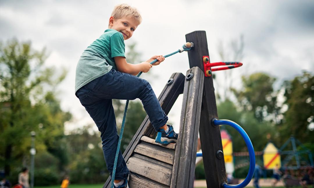 Little boy climbing on the playground