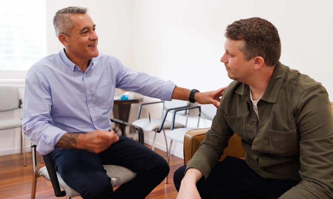 Indigenous doctor talking with his patient in the waiting room
