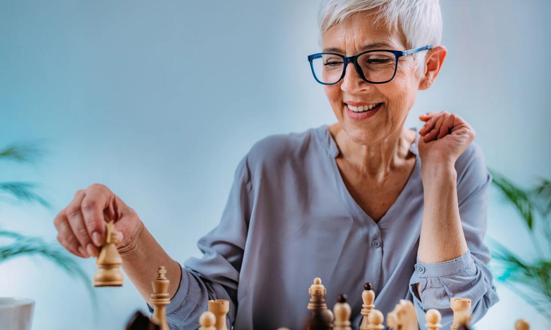 Cognitive Rehabilitation Activity. Senior Woman Playing Chess.