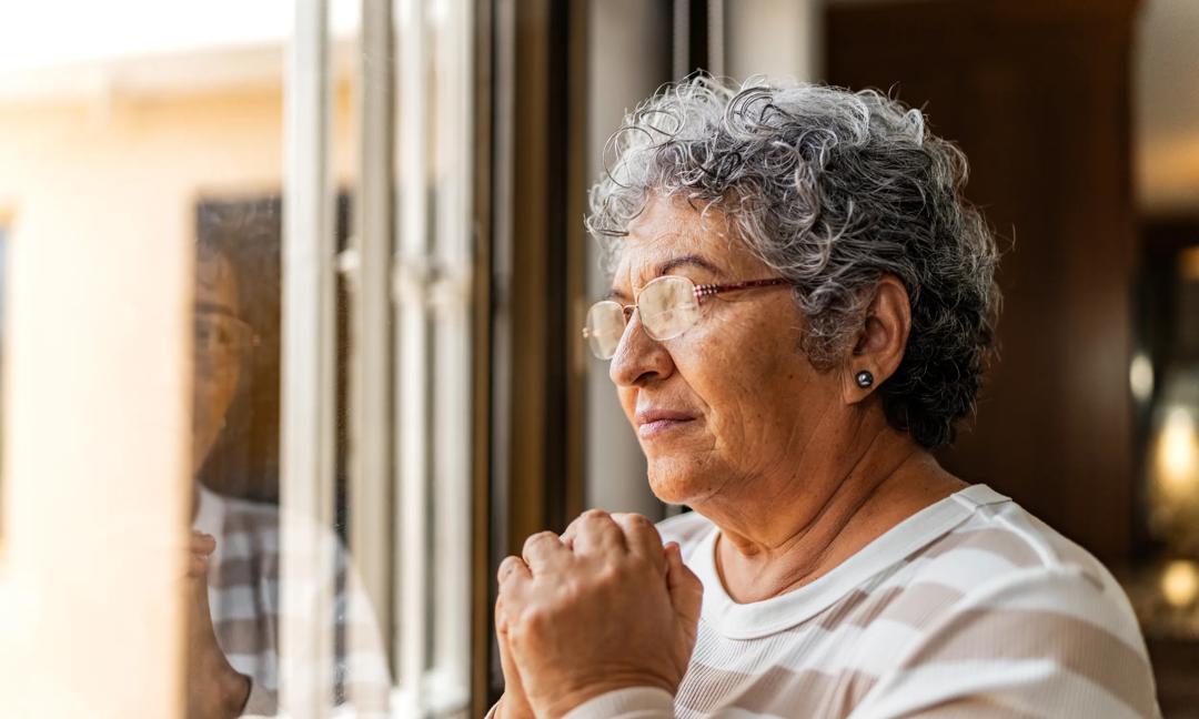 Senior woman contemplating at home