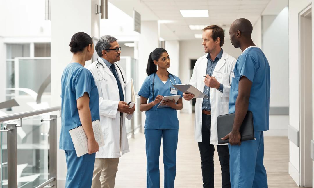 Doctor, nurse and medical meeting with tablet, paper and lab data for medicine innovation idea and research in hospital. Teamwork, healthcare leadership and collaboration communication in help clinic