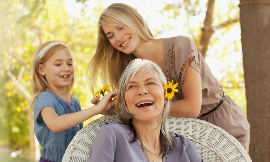 Three generations of women playing outdoors
