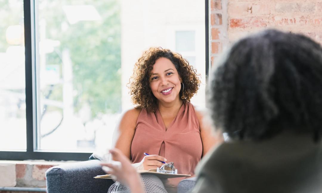 Confident female therapist listening to patient