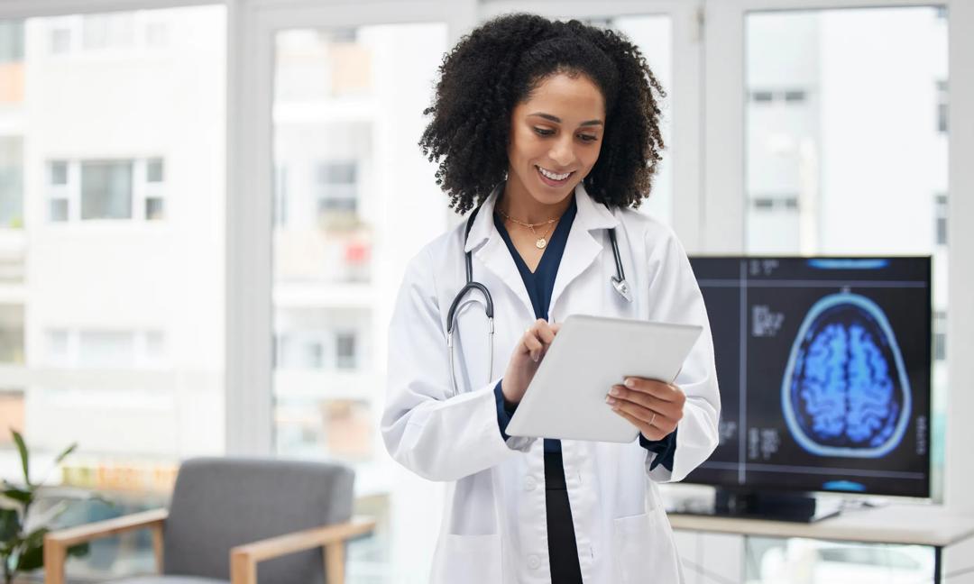 Neurology, doctor and planning surgery with tablet in office with x ray, results and patient data on tech for expert consultation. Cancer, research and black woman to study the brain or neuroscience