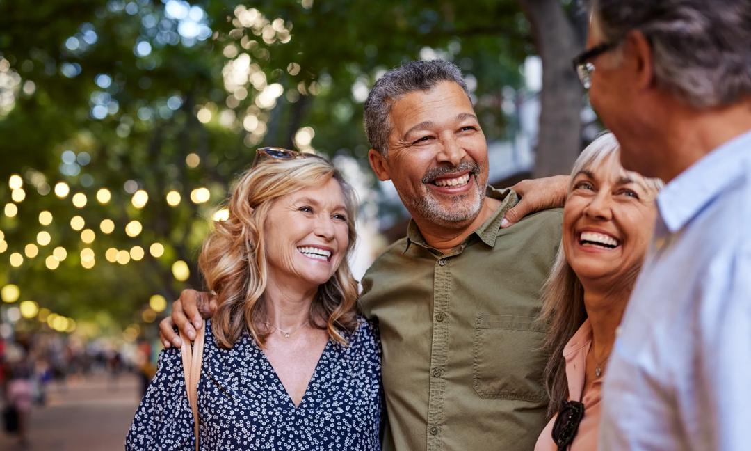Mature women and men laughing together