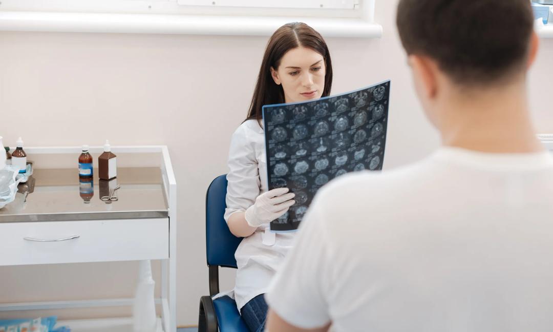 Serious professional doctor examining the X ray photo