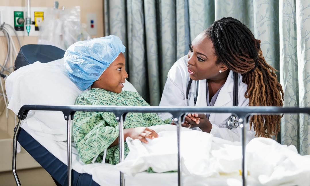 Doctor in hospital talking to child patient