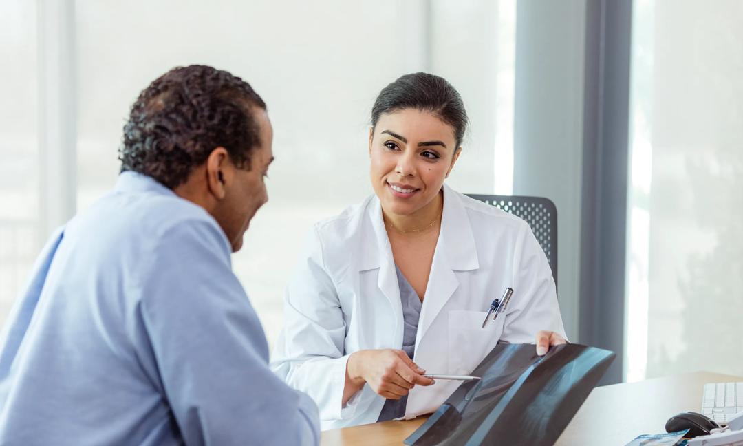Doctor reviewing x-ray with patient during consultation