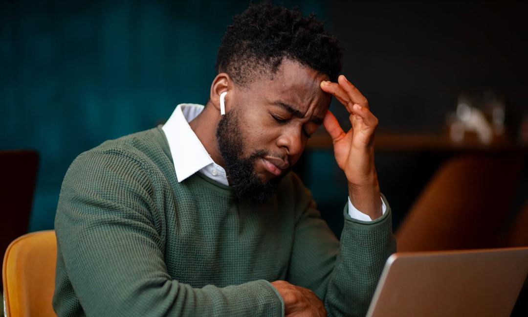 Young man dealing with stress and headache
