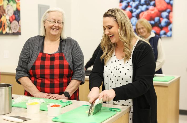 Action shots of people cooking in a Culinary Medicine Class