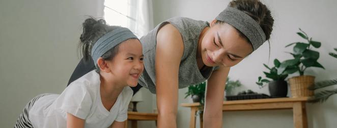 Mother and daughter doing yoga