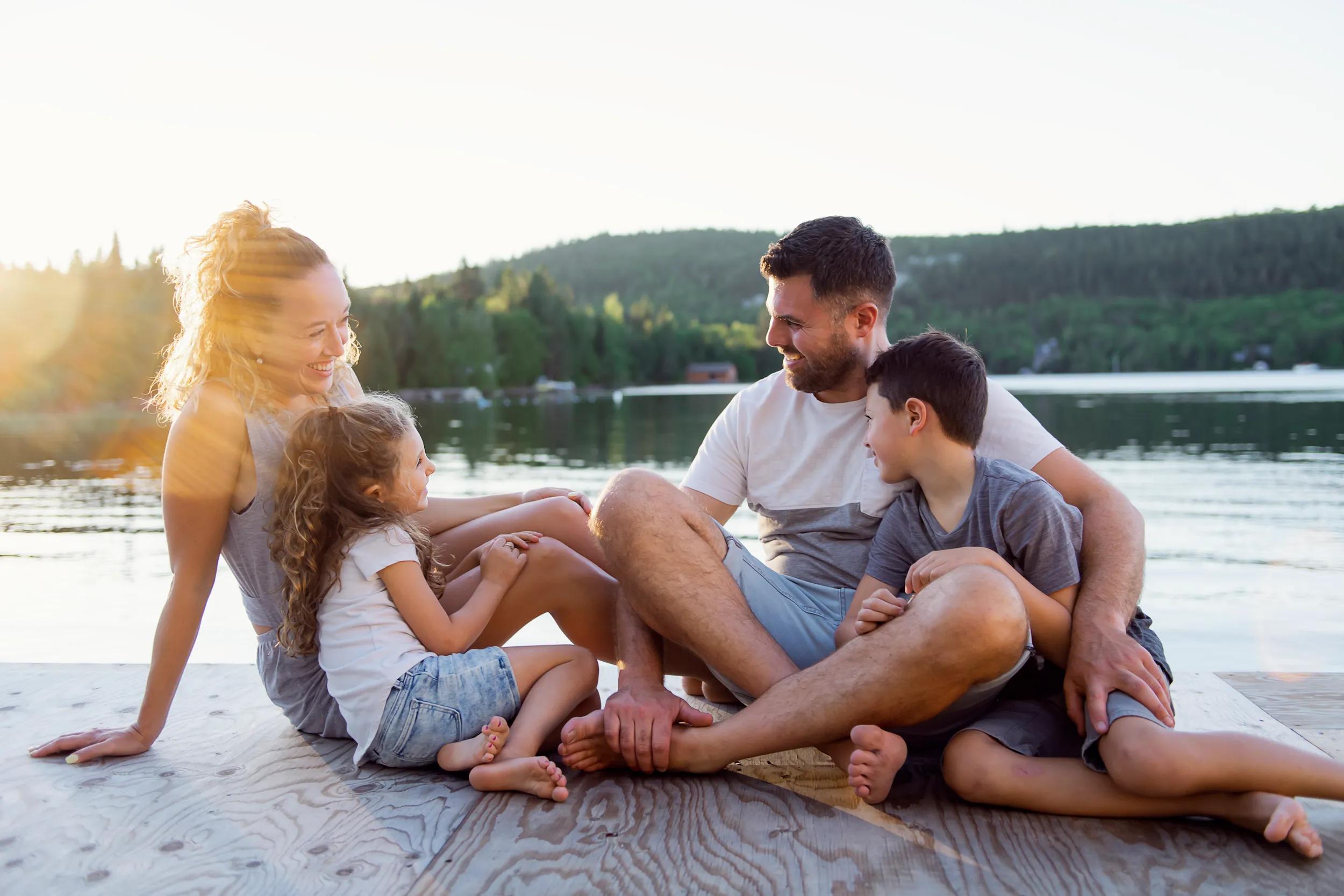 A family on the pier warm summer day having good time
