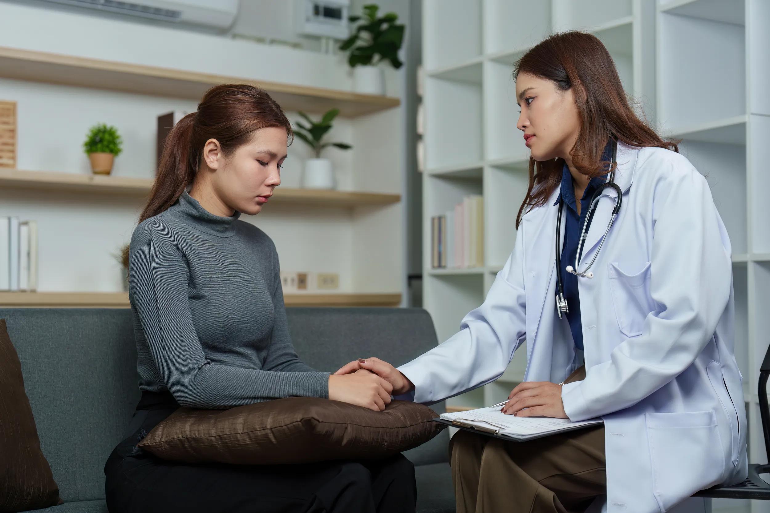 Mental Health Support. Doctor comforting a distressed patient during a consultation.